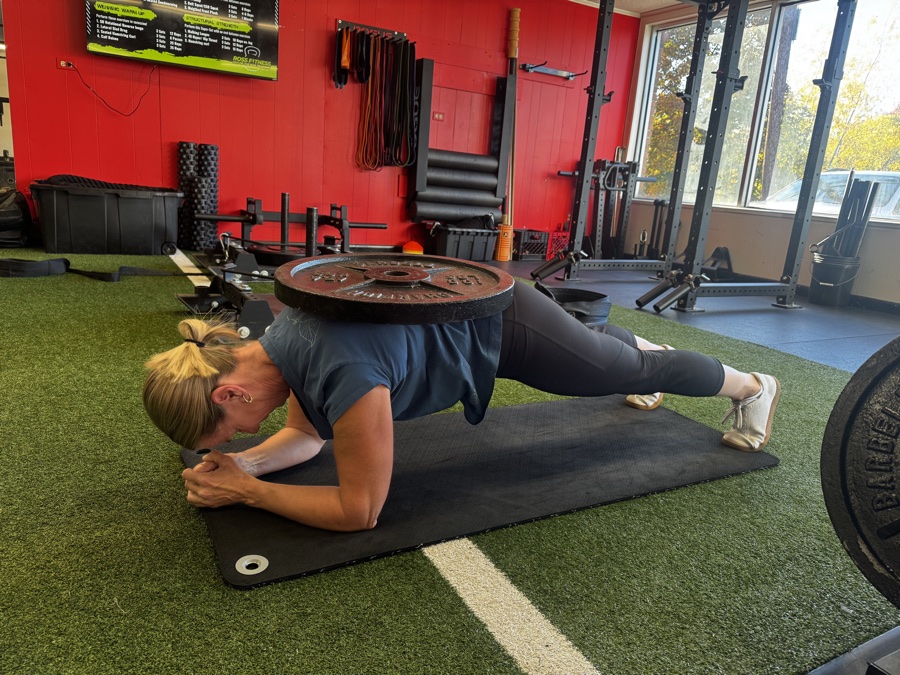 A Ross Fitness member doing a weighted plank